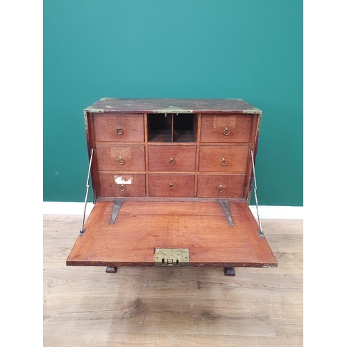 584 - A 19th Century teak and brass bound Campaign Escritoire with fall front enclosing eight drawers with... 