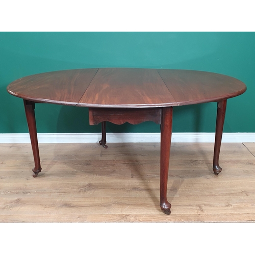 587 - A George II mahogany dropleaf Dining Table mounted upon turned tapering legs and pad feet with later... 