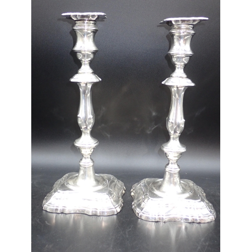 59 - A pair of Edward VII silver Candlesticks with knopped stems on shaped square bases, Sheffield 1906, ... 