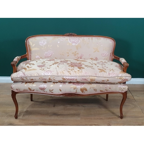 593 - A pair of French beechwood framed Elbow Chairs with cream silk upholstery and rose and gilt foliate ... 