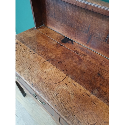 594 - An antique oak Dresser with boarded rack, the base fitted three drawers above shaped frieze on squar... 