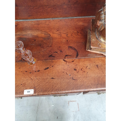 594 - An antique oak Dresser with boarded rack, the base fitted three drawers above shaped frieze on squar... 