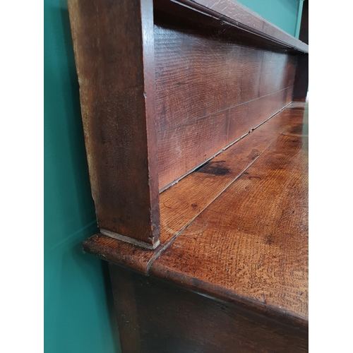 594 - An antique oak Dresser with boarded rack, the base fitted three drawers above shaped frieze on squar... 