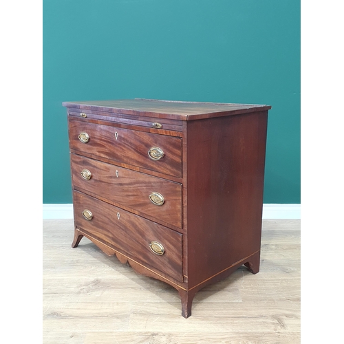 601 - A late Georgian mahogany Dressing Chest with brushing slide above three long drawers on splay feet, ... 