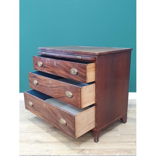 601 - A late Georgian mahogany Dressing Chest with brushing slide above three long drawers on splay feet, ... 