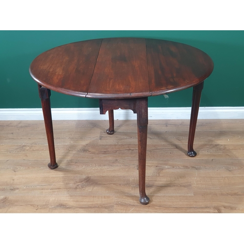 603 - A 19th Century Cuban mahogany dropleaf Table with cupid's bow frieze having oval top and raised on t... 