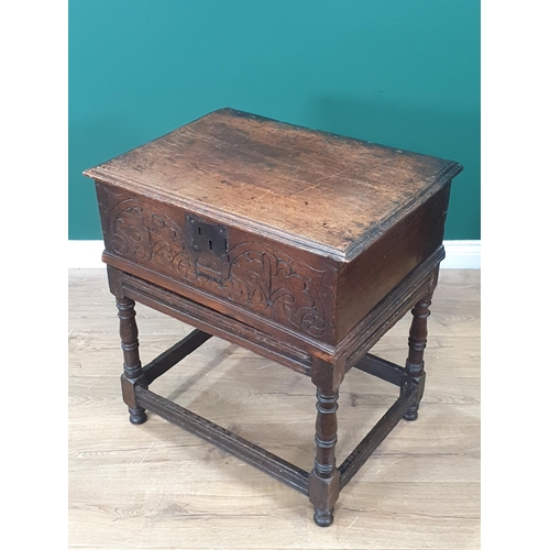 605 - An 18th Century oak Blanket Box on Stand with moulded hinged top, carved front, the stand with turne... 