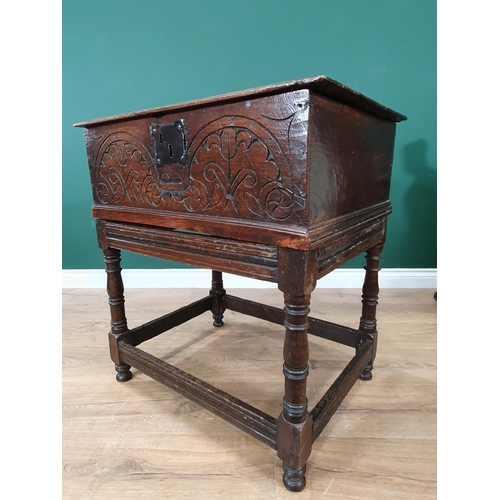 605 - An 18th Century oak Blanket Box on Stand with moulded hinged top, carved front, the stand with turne... 