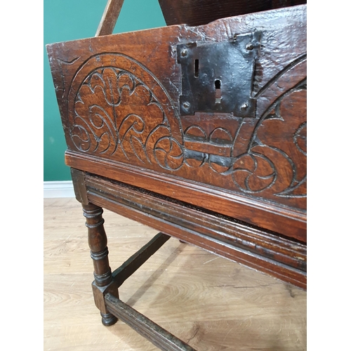 605 - An 18th Century oak Blanket Box on Stand with moulded hinged top, carved front, the stand with turne... 