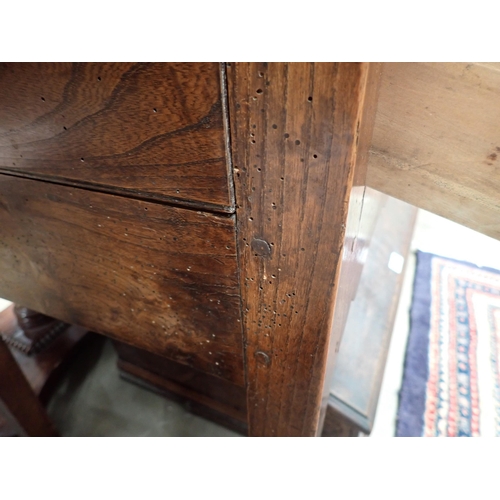 613 - An 18th Century Shropshire elm Dresser Base fitted three drawers on squared supports with shaped fri... 