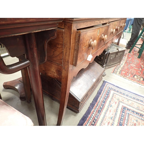 613 - An 18th Century Shropshire elm Dresser Base fitted three drawers on squared supports with shaped fri... 