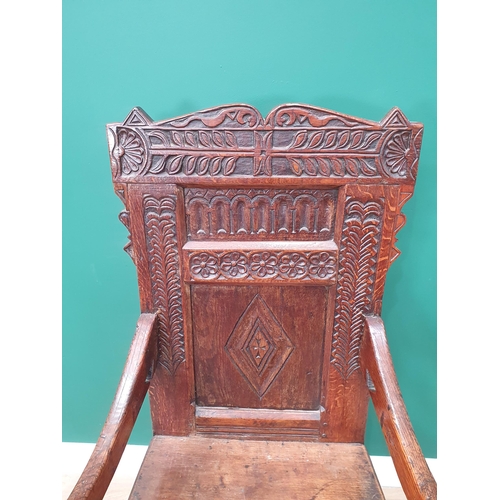 620 - A late 17th Century oak Wainscot Chair with leafage carved shaped top rail above nulled and lozenge ... 