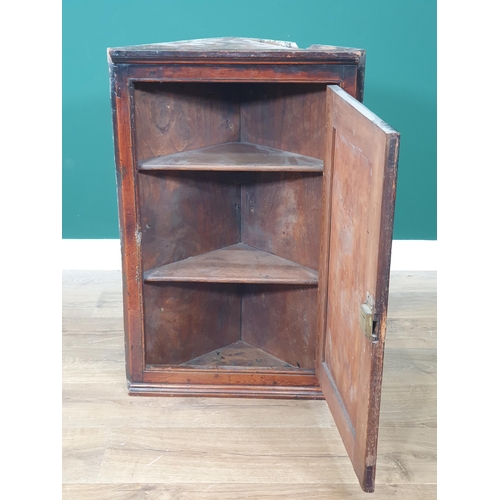 627 - An antique pine and fruitwood small hanging Corner Cupboard with figured fielded panel door having H... 