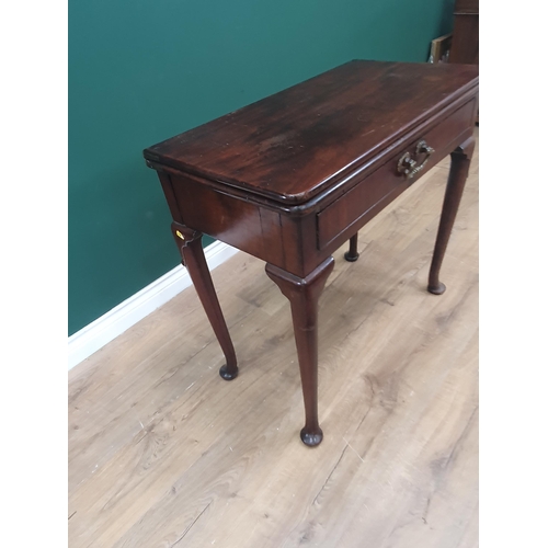 628 - A Georgian mahogany Card Table with fold-over top supported on two swing supports, the turned suppor... 