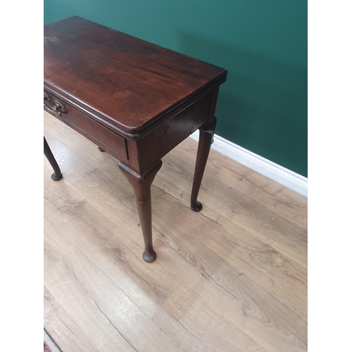 628 - A Georgian mahogany Card Table with fold-over top supported on two swing supports, the turned suppor... 