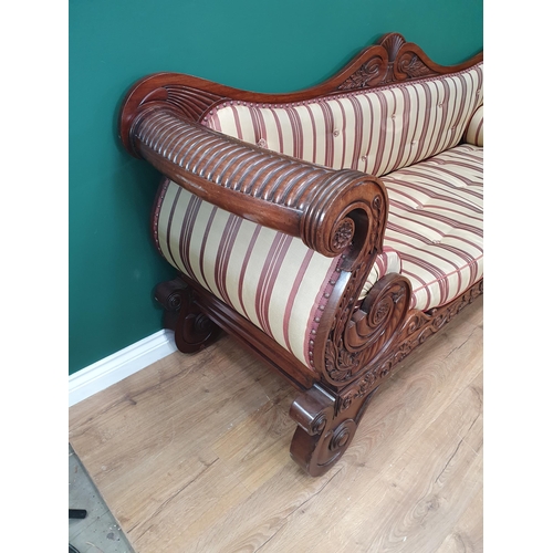 632 - A Regency carved mahogany Settee, the shaped back and rolled arms above a cushion seat raised on scr... 