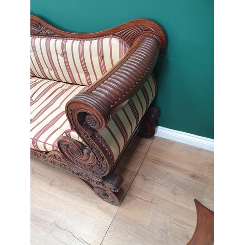 632 - A Regency carved mahogany Settee, the shaped back and rolled arms above a cushion seat raised on scr... 