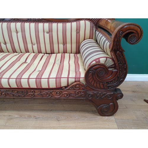 632 - A Regency carved mahogany Settee, the shaped back and rolled arms above a cushion seat raised on scr... 