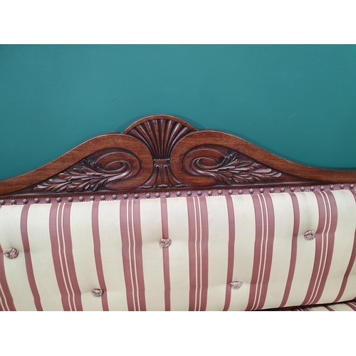 632 - A Regency carved mahogany Settee, the shaped back and rolled arms above a cushion seat raised on scr... 