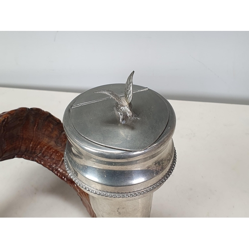 64 - A Ram's Horn Snuff Mull with plated mounts including a figure of an eagle to the hinged cover, 12in