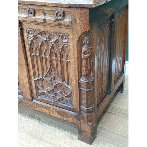 640 - An oak Coffer with hinged panelled cover and four gothic carved tracery panels to the front, flanked... 