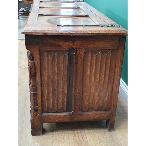 640 - An oak Coffer with hinged panelled cover and four gothic carved tracery panels to the front, flanked... 