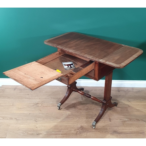 645 - A Regency mahogany Writing Table with drop leaves, fitted two drawers, the top drawer fitted with wr... 