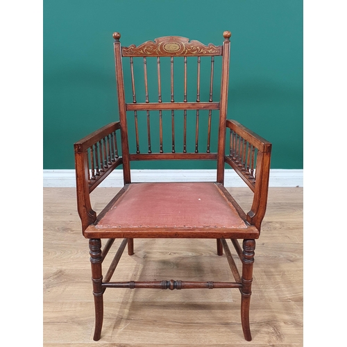 647 - A late 19th Century rosewood Elbow Chair with inlaid top rail above a spindle gallery and spindles t... 