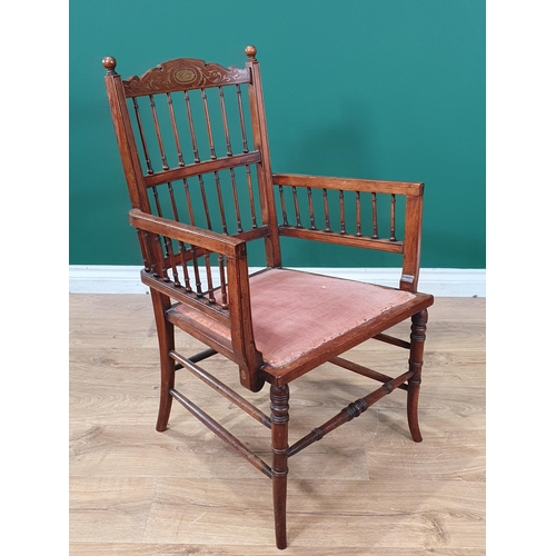 647 - A late 19th Century rosewood Elbow Chair with inlaid top rail above a spindle gallery and spindles t... 