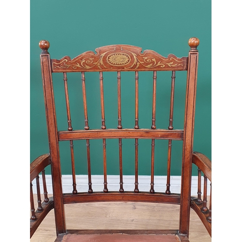 647 - A late 19th Century rosewood Elbow Chair with inlaid top rail above a spindle gallery and spindles t... 