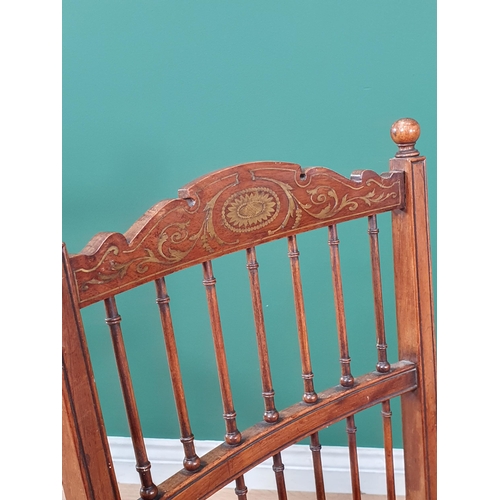 647 - A late 19th Century rosewood Elbow Chair with inlaid top rail above a spindle gallery and spindles t... 