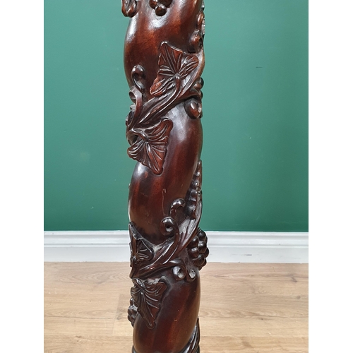 652 - A mahogany Torchiere Stand with trailing fruiting vine carving to column, mounted upon tripod base w... 