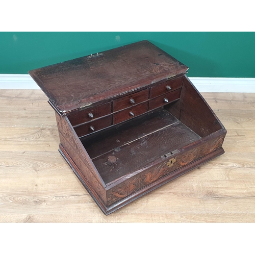 655 - A 17th Century oak Desk Box with sloping hinged cover enclosing six small drawers, the frieze carved... 