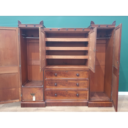 661 - A Regency mahogany sectional Wardrobe with inverted front, moulded top, central section having two p... 