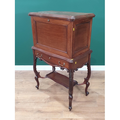 667 - A 1920's mahogany Desk with hinged top and front, opening to reveal a fitted interior of pigeon hole... 