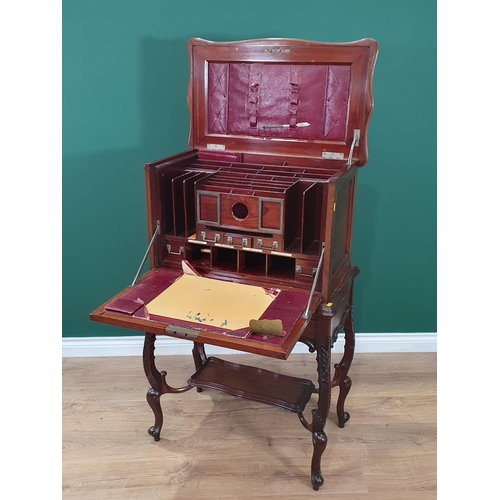 667 - A 1920's mahogany Desk with hinged top and front, opening to reveal a fitted interior of pigeon hole... 