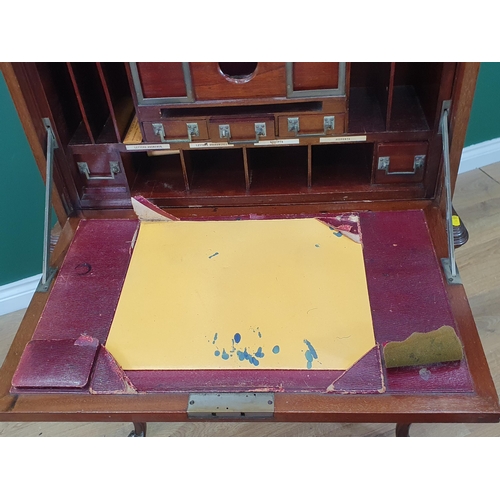 667 - A 1920's mahogany Desk with hinged top and front, opening to reveal a fitted interior of pigeon hole... 