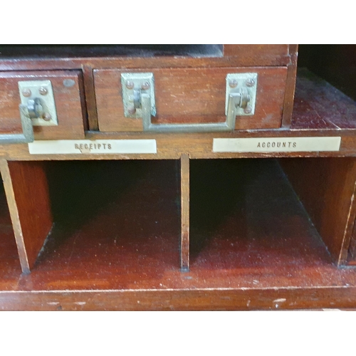 667 - A 1920's mahogany Desk with hinged top and front, opening to reveal a fitted interior of pigeon hole... 