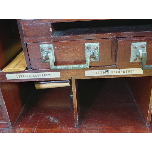 667 - A 1920's mahogany Desk with hinged top and front, opening to reveal a fitted interior of pigeon hole... 