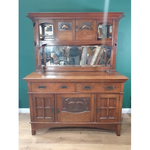 668 - An Art Nouveau oak Mirror-back Dresser with a pair of doors inset with stylised floral panels flanke... 