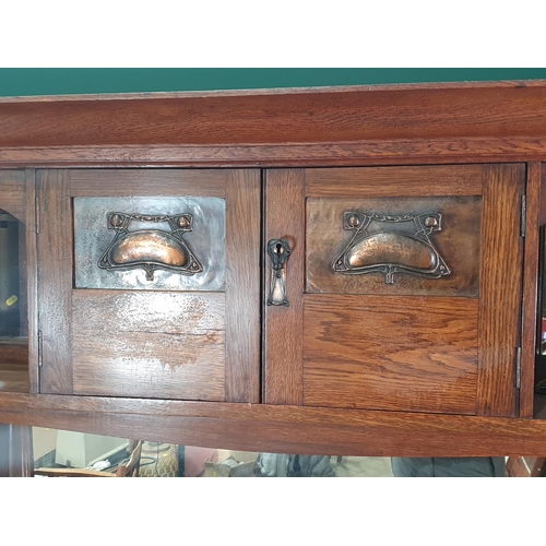 668 - An Art Nouveau oak Mirror-back Dresser with a pair of doors inset with stylised floral panels flanke... 