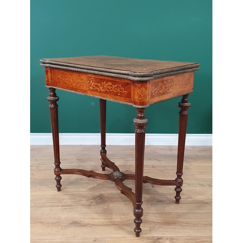 674 - A satinwood marquetry Card Table, the fold-over top with floral scrolled design, raised on fluted ta... 