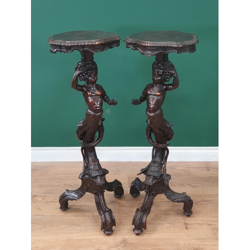 675 - A pair of 19th Century ebonised figural Tables, possibly Italian, the shaped tops supported on cheru... 