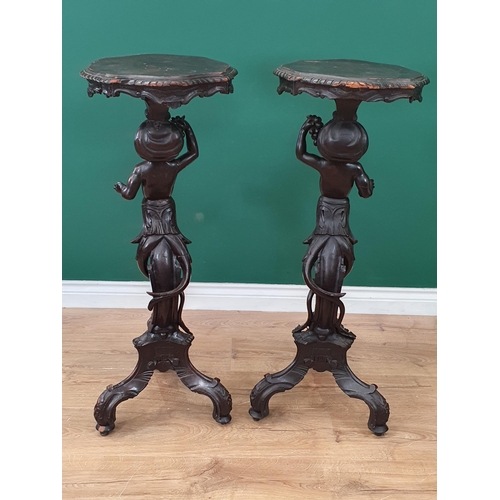 675 - A pair of 19th Century ebonised figural Tables, possibly Italian, the shaped tops supported on cheru... 