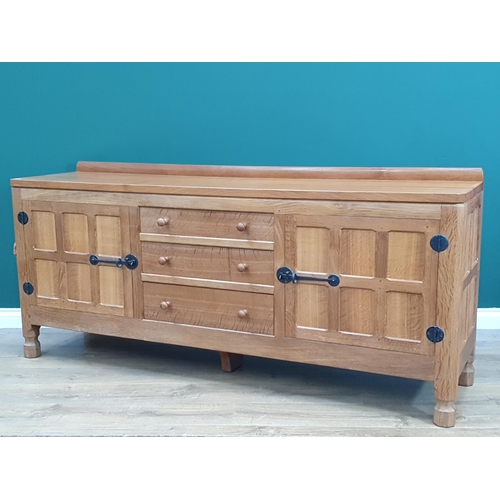 678 - A Mouseman Thompson oak Dresser Base with pair of six panel doors flanking three drawers, 6ft wide, ... 