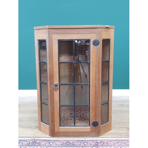 680 - A Mouseman Thompson oak Corner Cupboard with glazed door, having leaded glazing bars