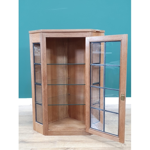 680 - A Mouseman Thompson oak Corner Cupboard with glazed door, having leaded glazing bars