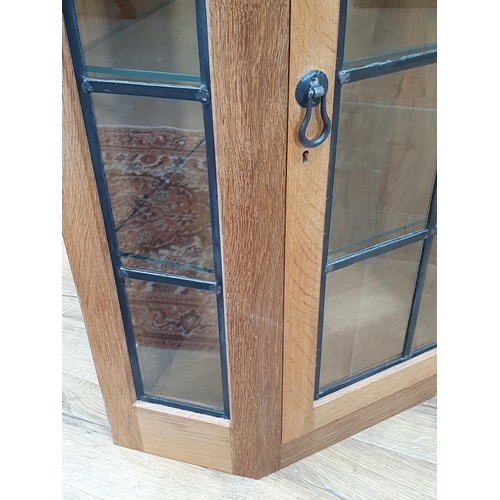 680 - A Mouseman Thompson oak Corner Cupboard with glazed door, having leaded glazing bars