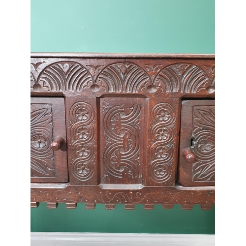 682 - A 17th Century and later oak Cupboard or Hutch fitted pair of carved doors mounted upon turned front... 