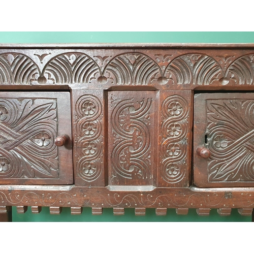 682 - A 17th Century and later oak Cupboard or Hutch fitted pair of carved doors mounted upon turned front... 